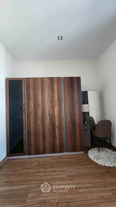 Spacious bedroom with modern wardrobe and cozy study corner