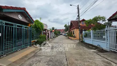 Charming residential street with colorful houses and lush greenery, perfect for family living.