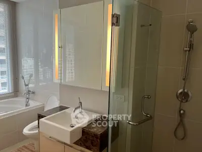 Modern bathroom with glass shower and bathtub in luxury apartment