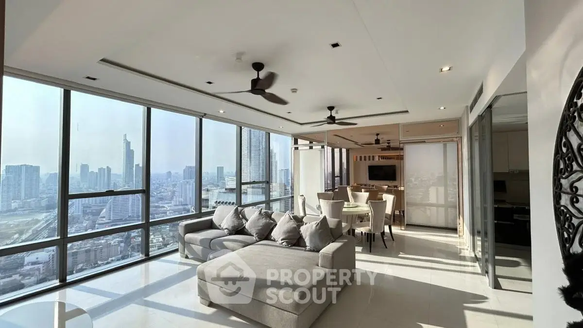Luxurious high-rise living room with panoramic city views and modern furnishings.