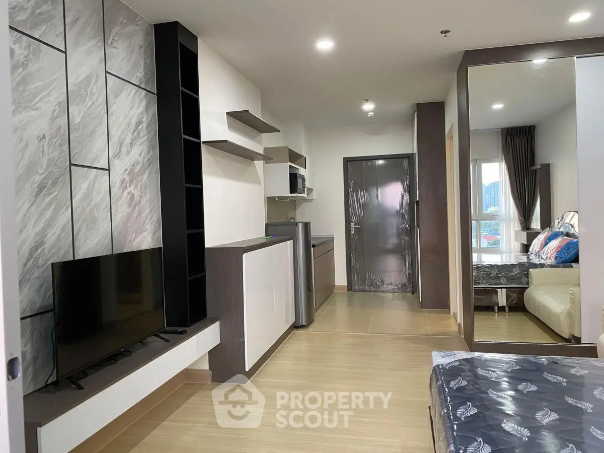 Modern apartment interior with stylish living area and sleek kitchen design.