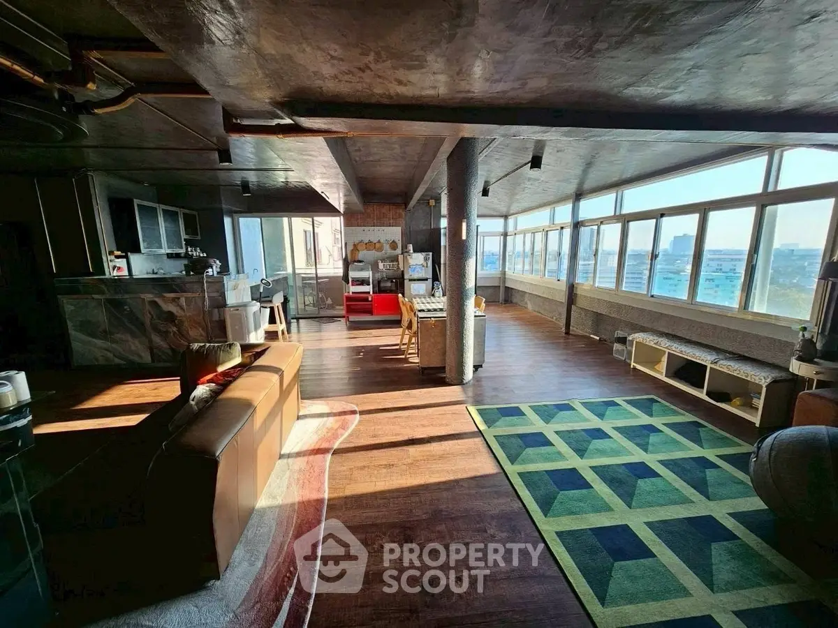 Spacious open-plan living room with panoramic windows and modern decor