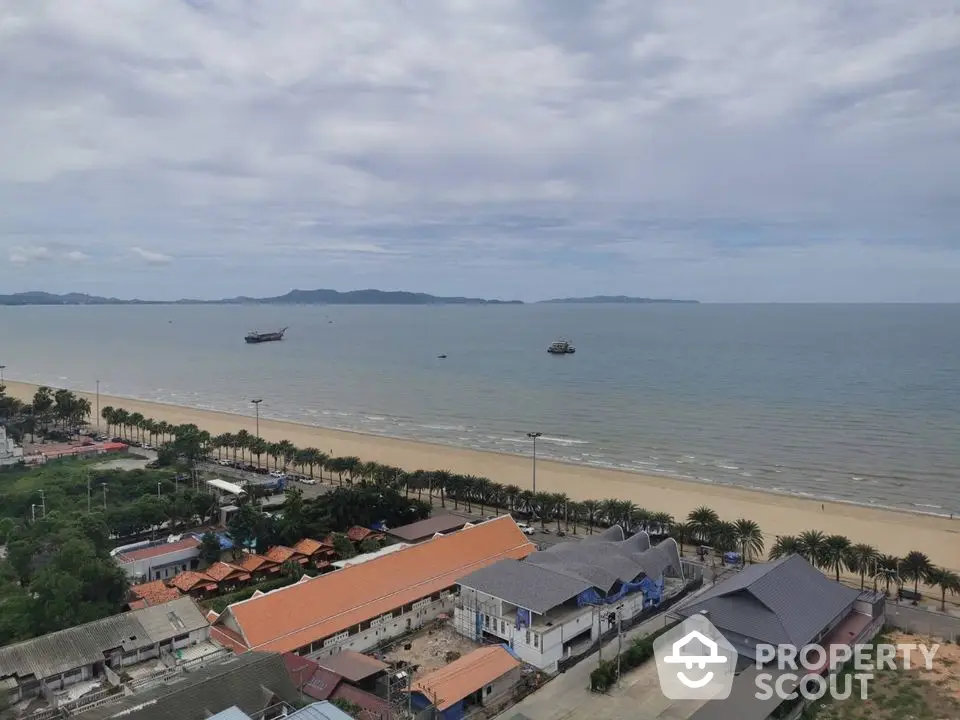 Stunning beachfront view with palm-lined shore and distant islands, perfect for serene coastal living.