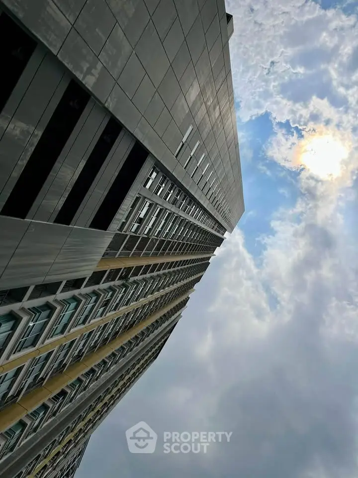 Stunning modern high-rise building against a vibrant sky, showcasing architectural elegance and urban living.