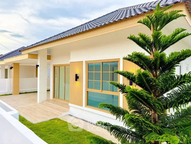 Modern single-story house with stylish facade and lush green lawn