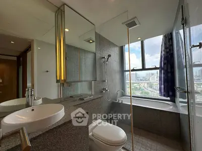 Luxurious bathroom with city view, featuring modern fixtures and a spacious bathtub.