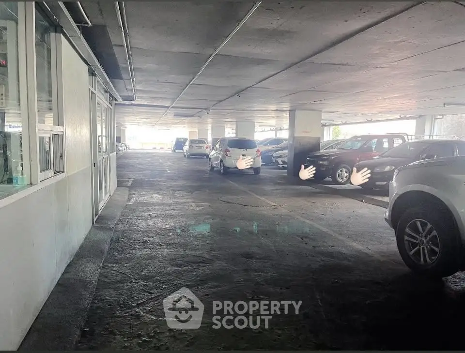 Spacious indoor parking area with multiple cars in a well-lit garage.