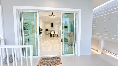 Modern open-plan living room with sliding glass doors and elegant interior design.