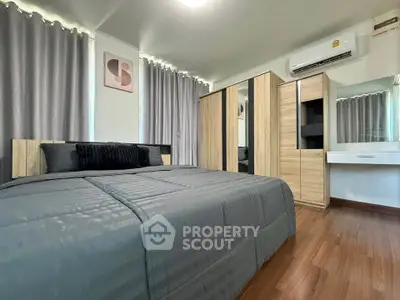 Modern bedroom with stylish decor and ample storage space