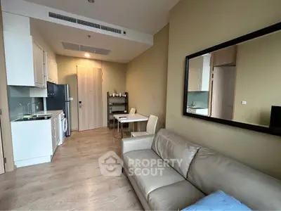 Modern apartment interior with cozy living room and compact kitchen featuring sleek appliances.