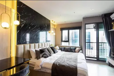 Luxurious modern bedroom with elegant decor and city view balcony.