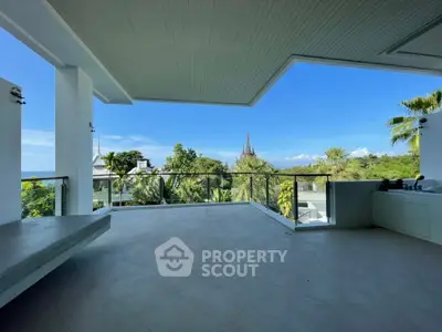 Spacious balcony with stunning panoramic views of lush greenery and blue skies, perfect for relaxation and entertainment.