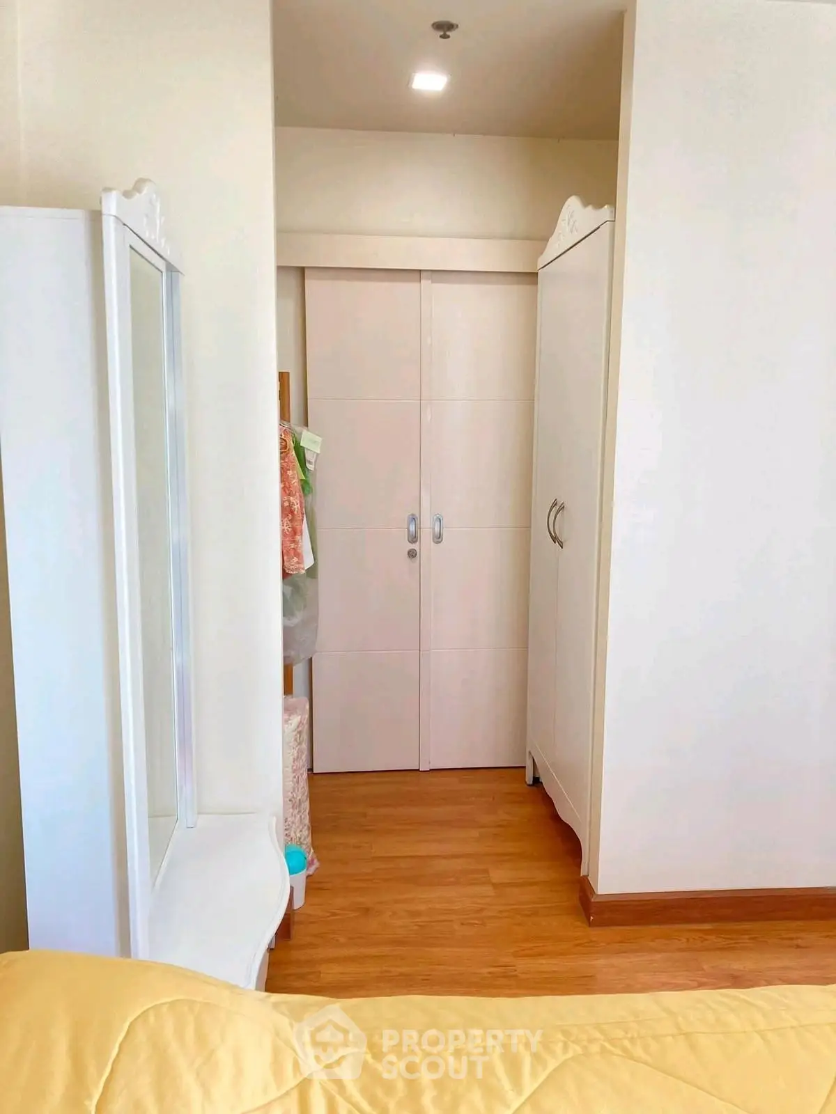 Cozy bedroom with elegant wardrobe and wooden flooring