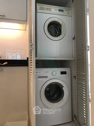Compact laundry area with stacked washer and dryer in modern home