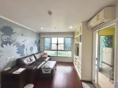Stylish living room with floral accent wall and city view, featuring leather sofa and built-in shelving.