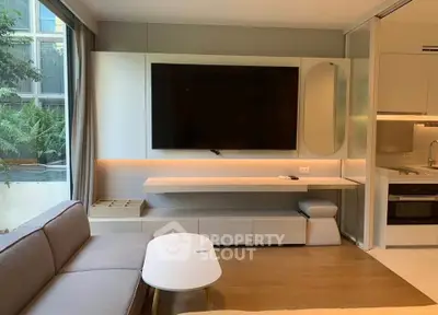 Modern living room with sleek TV setup and cozy seating area