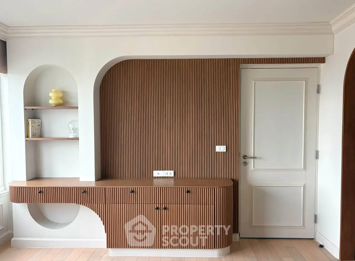 Stylish modern interior with unique wood paneling and built-in shelves, perfect for contemporary living.