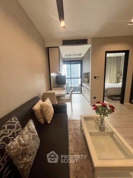 Modern living room with elegant decor and city view from balcony, featuring cozy seating and stylish dining area.