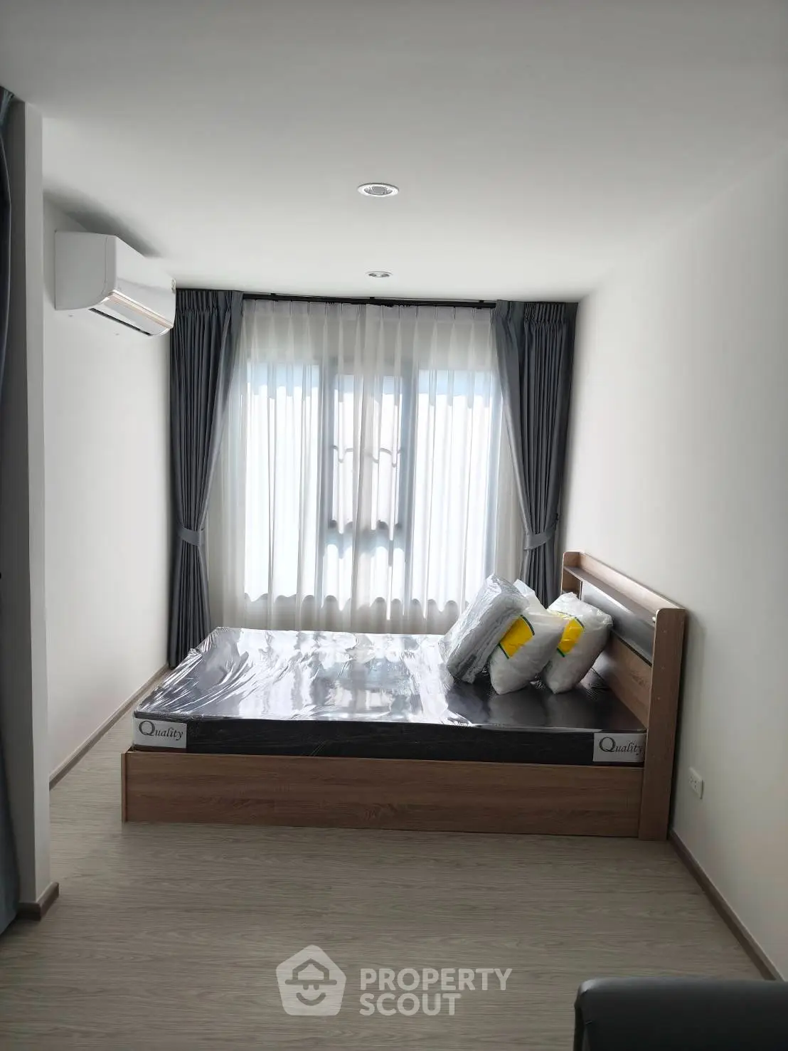 Modern bedroom with sleek design and natural light, featuring a comfortable bed and stylish curtains.