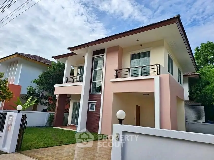 Charming two-story house with modern design and lush green lawn