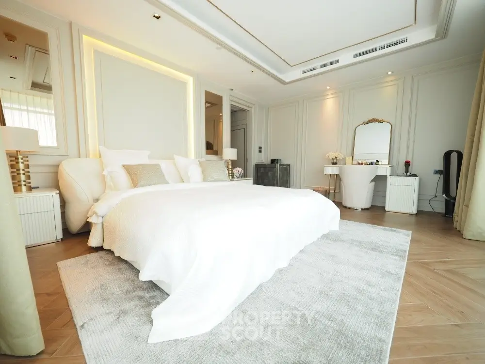 Luxurious bedroom with elegant decor and plush bedding in a modern home.