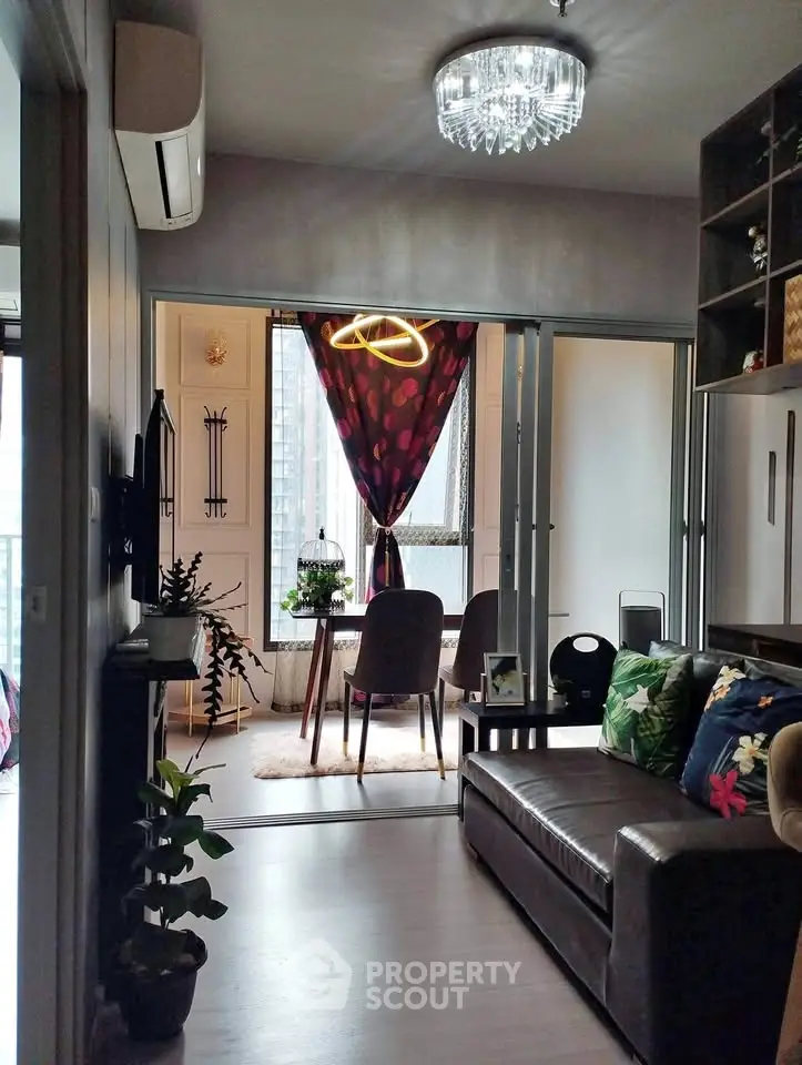 Stylish living room with modern decor and elegant dining area in a cozy apartment.