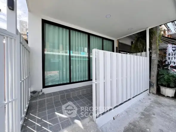 Modern exterior entrance with sleek design and privacy fence