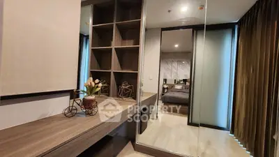 Modern bedroom with stylish shelving and mirrored closet doors