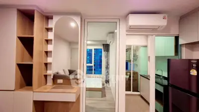 Modern apartment interior with open kitchen and living area, featuring sleek design and air conditioning.