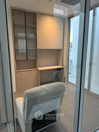 Modern study room with sleek cabinetry and comfortable chair