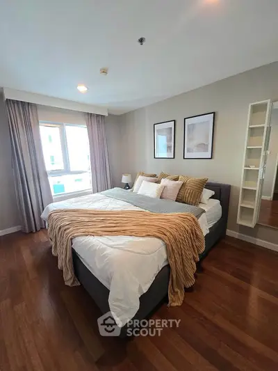 Cozy bedroom with elegant decor and large window for natural light