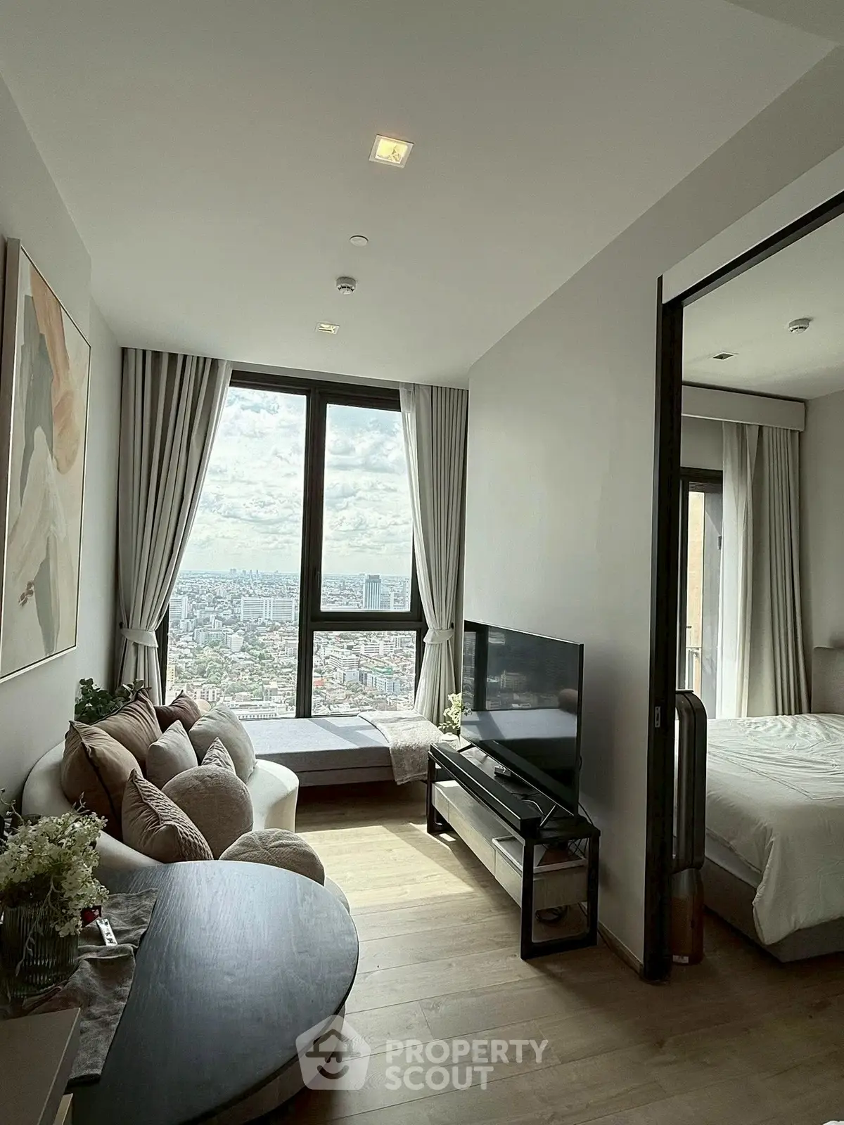Modern living room with panoramic city view and cozy furnishings