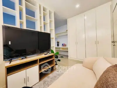 Modern living room with sleek TV unit and ample storage space