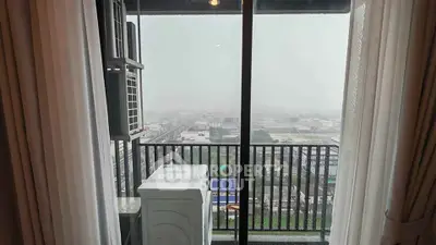 High-rise balcony with city view and washing machine, perfect urban living space.