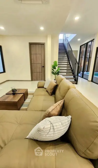 Spacious modern living room with elegant beige sofa and stylish decor