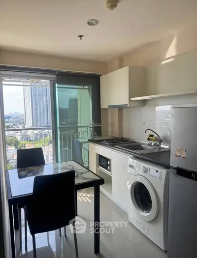 Modern kitchen with city view, featuring sleek appliances and dining area, perfect for urban living.