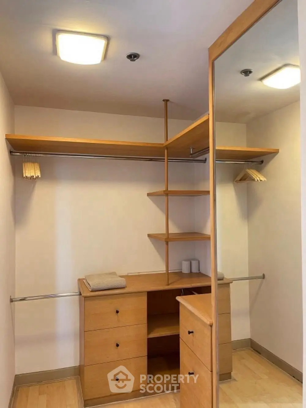 Spacious walk-in closet with wooden shelves and ample storage space.