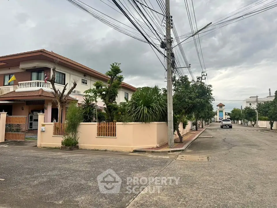 Charming suburban house with lush greenery and spacious driveway in a peaceful neighborhood.