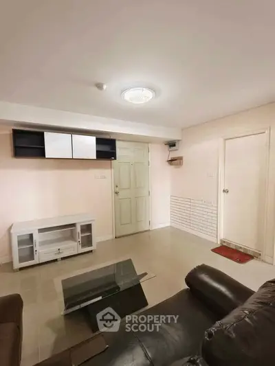 Spacious living room with modern furniture and sleek design, perfect for relaxation and entertainment.