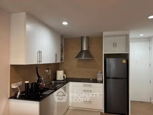 Modern kitchen with sleek white cabinets and stainless steel appliances