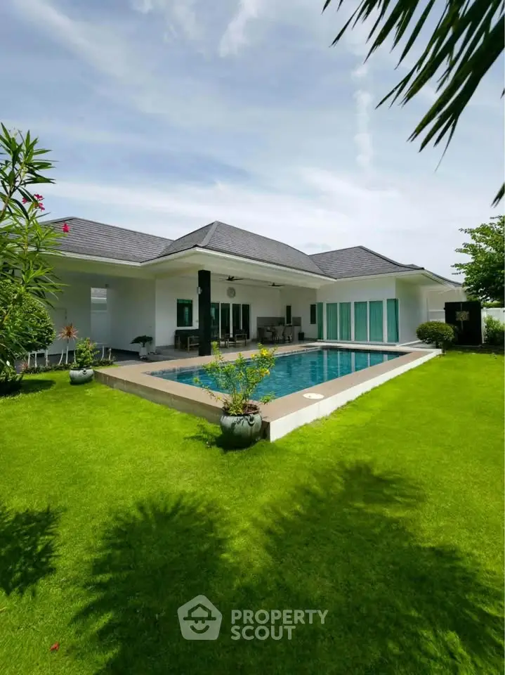Luxurious modern villa with private pool and lush green garden, perfect for serene living.