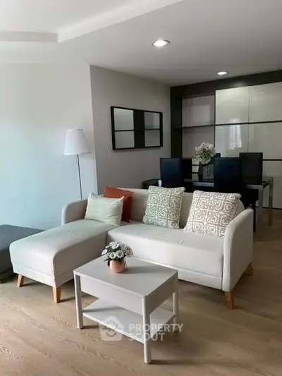 Modern living room with stylish sofa and dining area, perfect for cozy gatherings.
