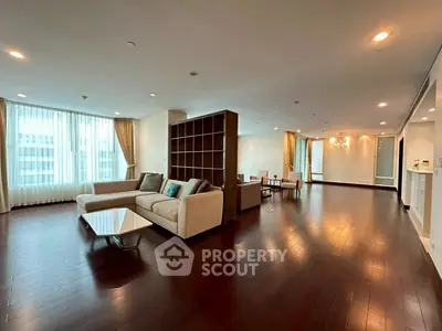 Spacious modern living room with elegant hardwood floors and large windows