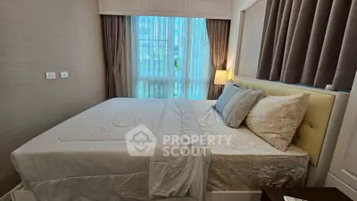 Cozy bedroom with elegant decor and large window for natural light