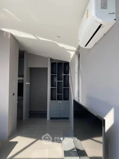 Modern living room with sleek air conditioning and stylish TV setup
