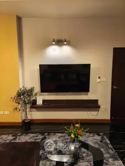 Modern living room with wall-mounted TV and stylish decor