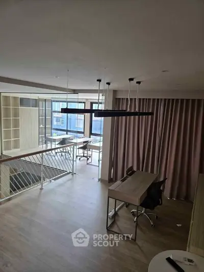 Modern study area with sleek desk and large windows in a stylish apartment.