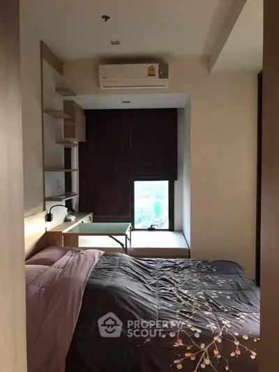 Cozy bedroom with modern decor and city view, featuring a comfortable bed and stylish desk.