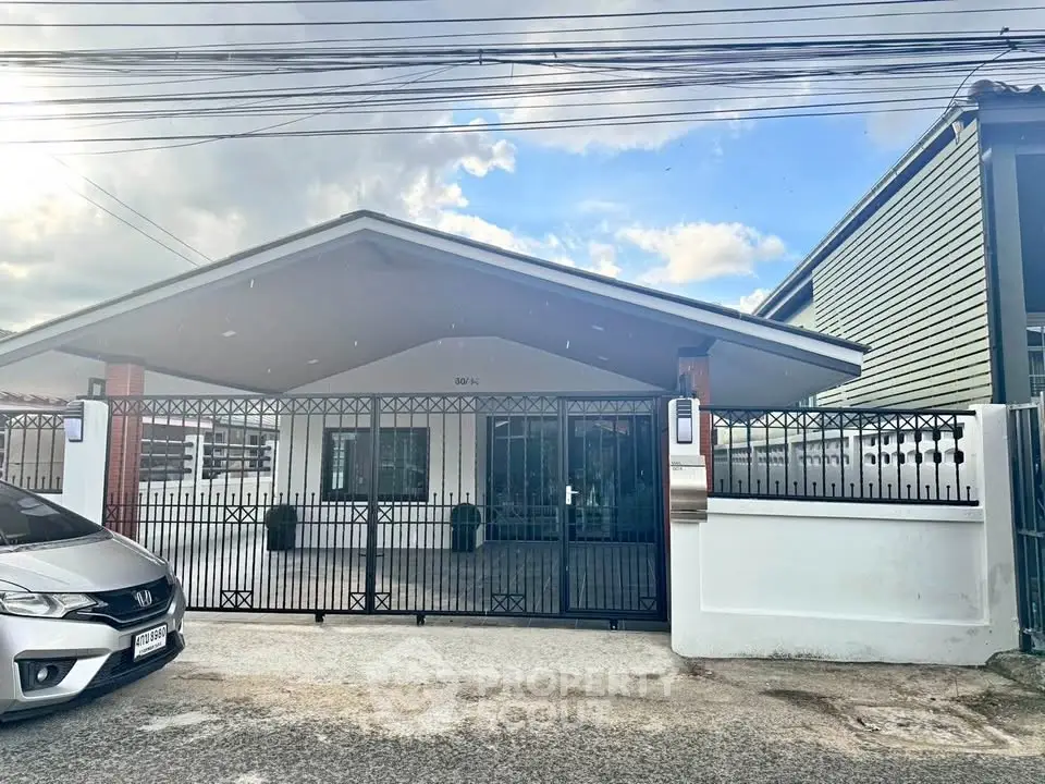 Charming single-story house with gated entrance and modern design in a serene neighborhood.