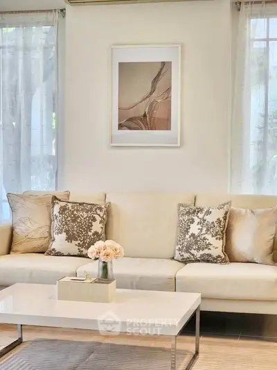 Elegant living room with stylish decor and neutral tones, featuring a cozy sofa and chic coffee table.